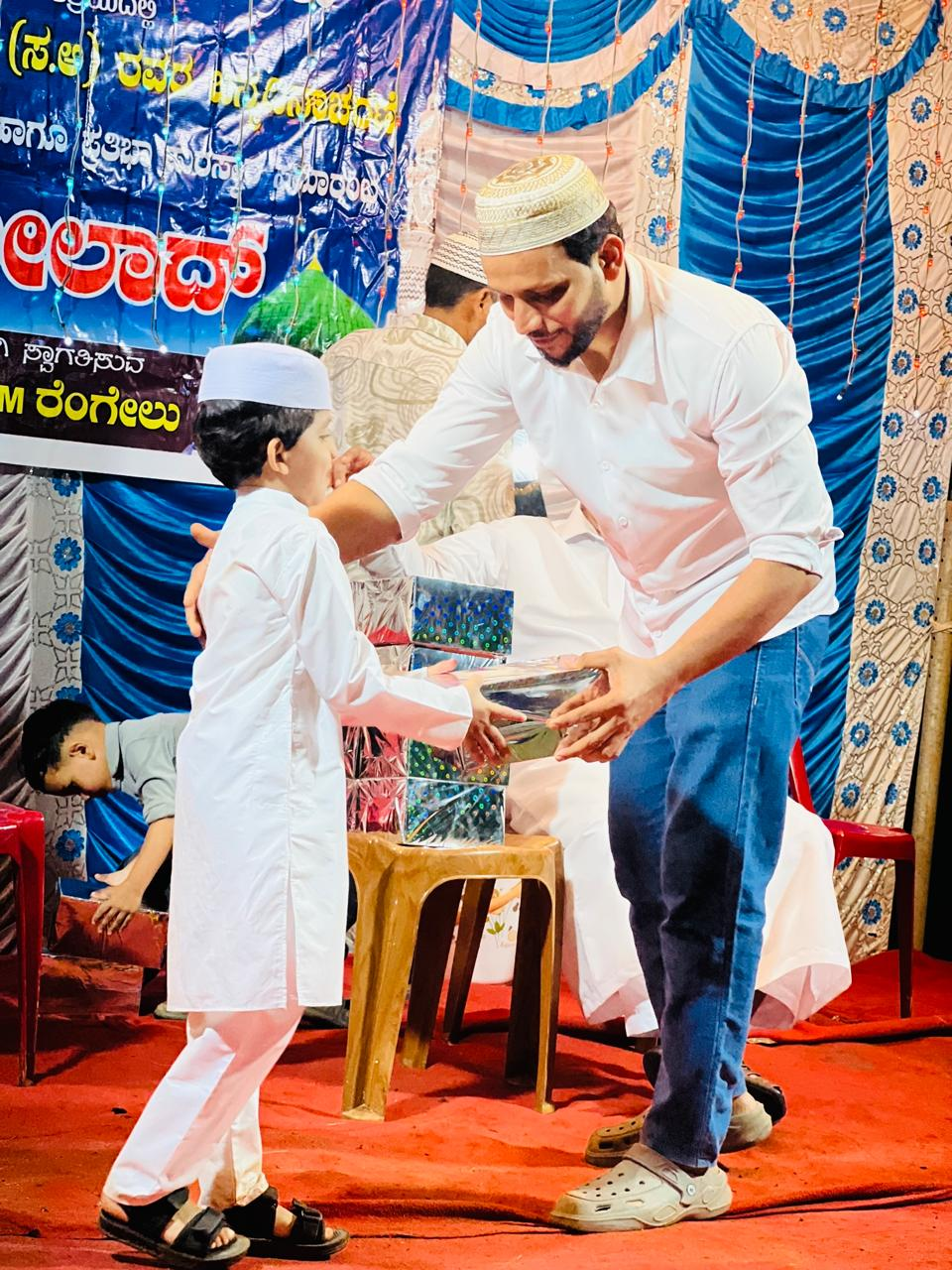 Student receiving recognition at a Badriya Youth Wing event